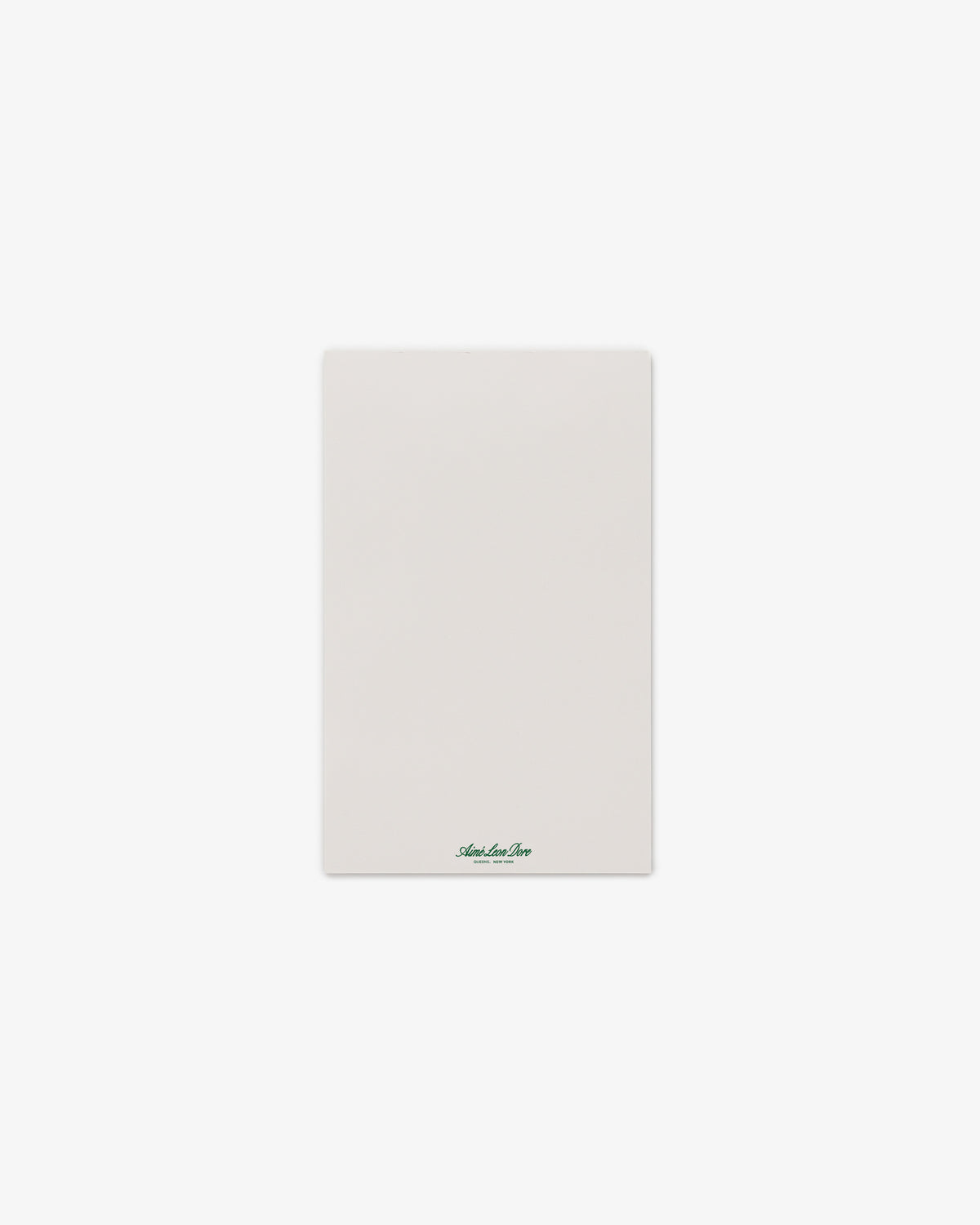 A Small Sketch Pad with a blank white sheet and small green text at the bottom center, on a plain background.