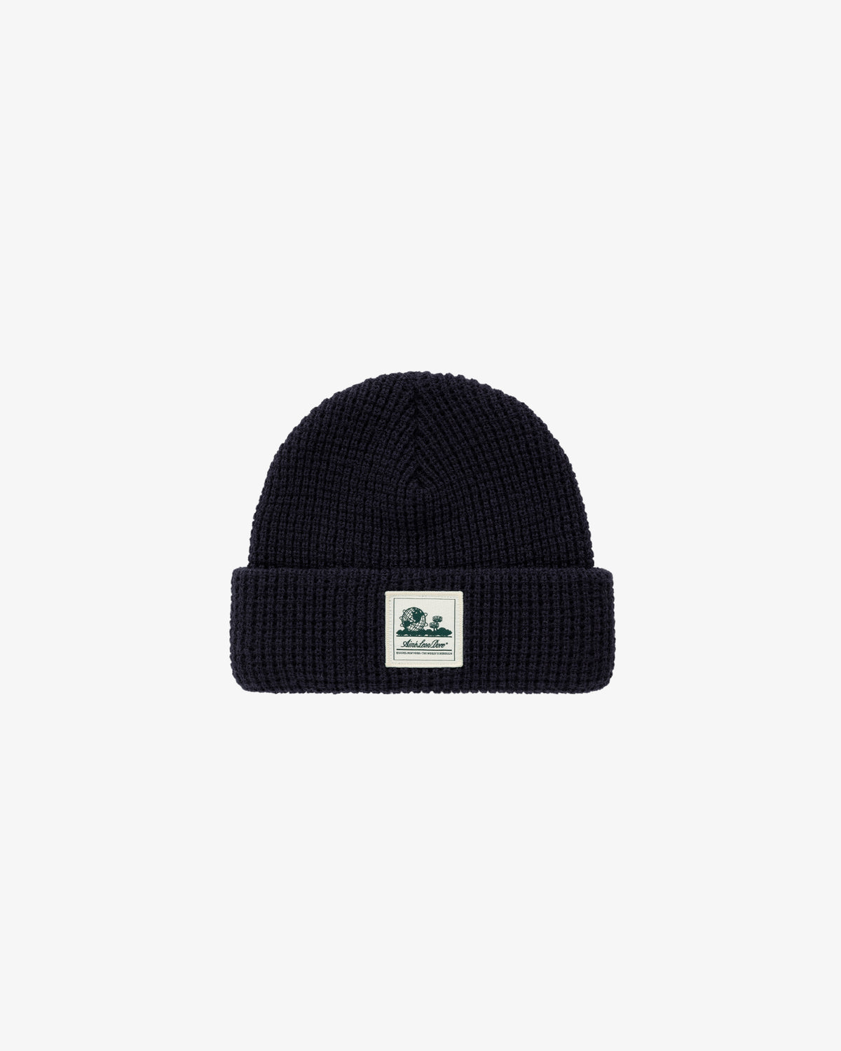 A black Waffle Knit Beanie with a folded brim and a white rectangular patch on the front.